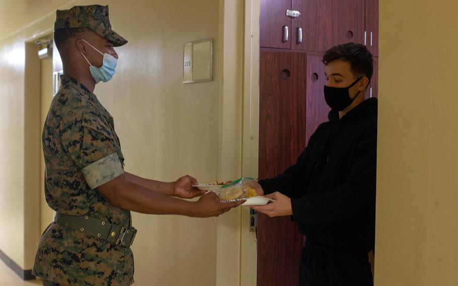 A Marine delivers food to a quarantined Marine on Camp Courtney, Okinawa, Japan, Aug. 16, 2020.