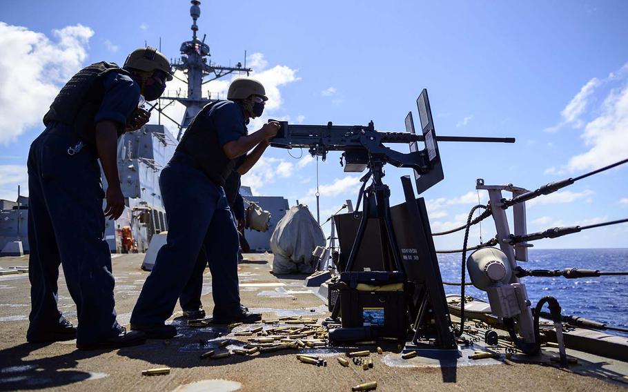 A sailor fires a .50-caliber machine gun aboard the guided-missile destroyer USS Chung-Hoon during the Rim of the Pacific exercise Aug. 19, 2020, in waters near the Hawaiian Islands.