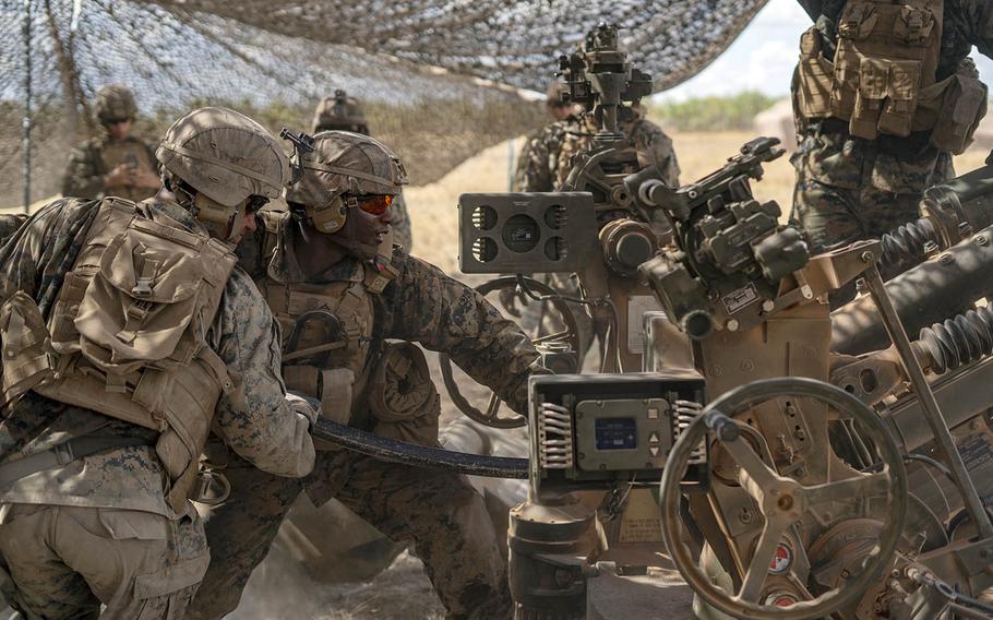 Cpl. Trey Teal and Lance Cpl. Andre Fair of the Marine Rotational Force — Darwin ground-combat element, prepare for a fire mission at Mount Bundey Training Area, Australia, Aug. 6, 2020.