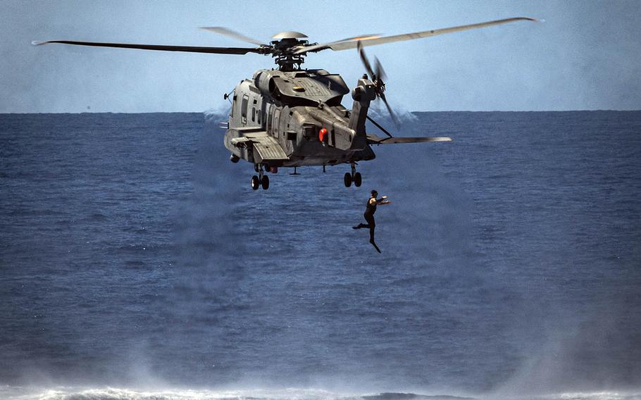 A diver from the Royal Canadian Navy ship HMCS Regina jumps into the Pacific Ocean as part of a diver training flight Aug. 22, 2020, during the Rim of the Pacific exercise near Hawaii. Royal Canadian Navy