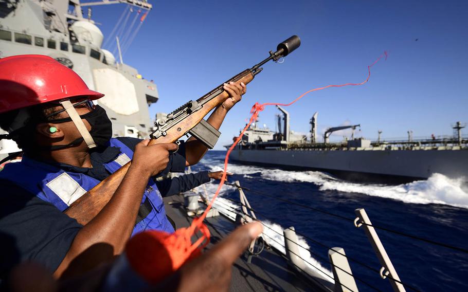 U.S. Navy Gunner's Mate Seaman Apprentice Isaiah Moore fires the shot line as the guided-missile destroyer USS Chung-Hoon conducts a replenishment-at-sea with the HMAS Sirius during the Rim of the Pacific exercise near Hawaii, Aug. 25, 2020. Devin Langer/U.S. Navy