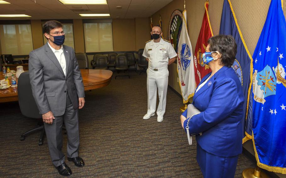 Defense Secretary Mark  Esper, left, and Rear Adm. John Menoni, commander of Joint Region Marianas, meet with Guam Gov. Lou Leon Guerrero in Asan, Guam, Aug. 29, 2020.