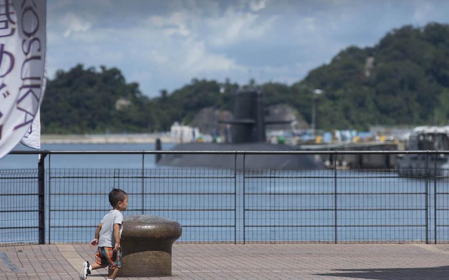 A child runs and plays outside Yokosuka Naval Base, Japan, Aug. 27, 2020.