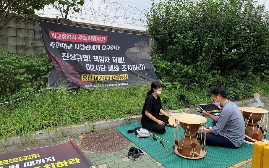 Members of the Progressive Korea University Student Association call for answers on the U.S. military's involvement in a fatal car crash during a sit-in outside Yongsan Garrison in Seoul, South Korea, Sept. 14, 2020.