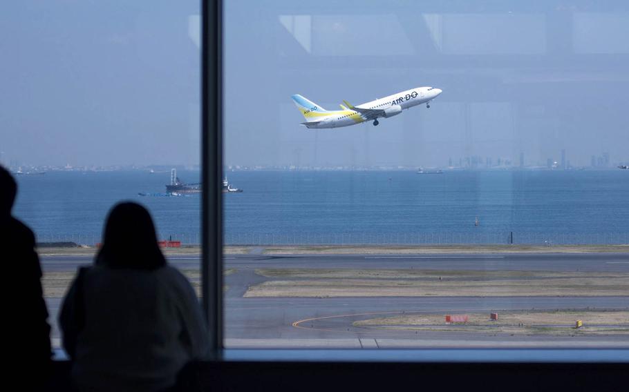 A flight takes off from Haneda International Airport in Tokyo, March 18, 2020.