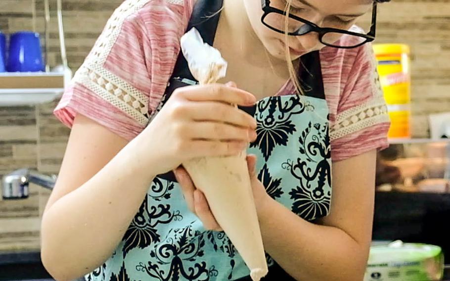 Kiri Peterson, founder of Operation Cake for Quarantine, finishes off deserts bound for people in quarantine at nearby Camp Humphreys, South Korea, Aug. 17, 2020.