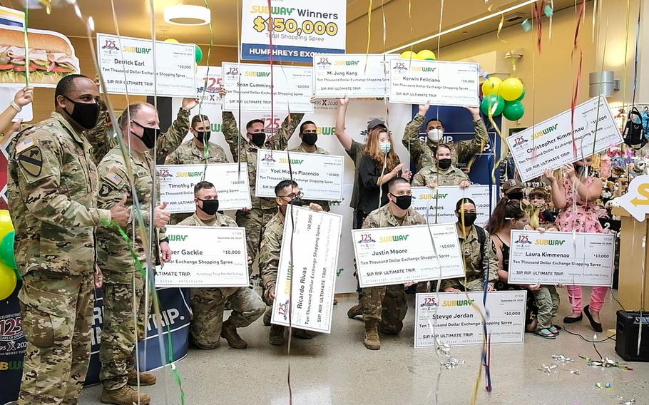 Fifteen winners of a $10,000 shopping spree celebrate at the post exchange on Camp Humphreys, South Korea, Thursday, Sept. 24, 2020.