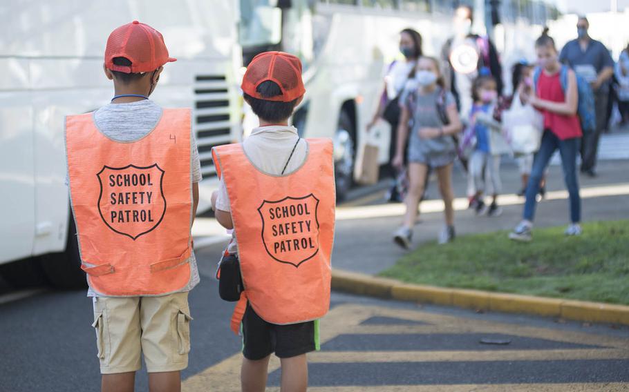 Safety patrol members look after their fellow Sullivans Elementary School students on the first day of in-person classes at Yokosuka Naval Base, Japan, Monday, Sept. 28, 2020.