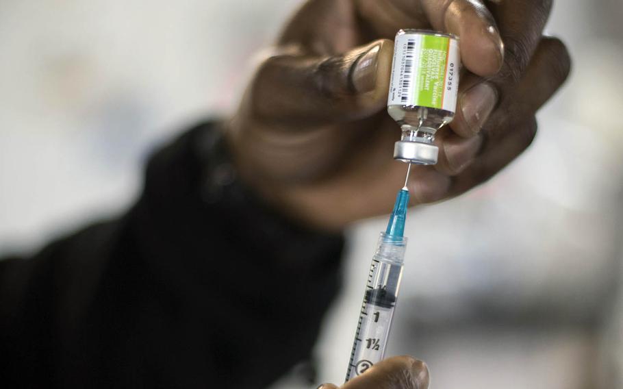 A hospital corpsman fills a syringe with the flu vaccine at Sasebo Naval Base, Japan, in 2017.