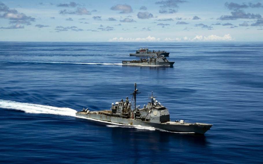 The USS Antietam, front, sails with the USS Germantown and USNS Sacagawea during the Valient Shield exercise near Guam, Sept. 25, 2020. A small fire broke out on the Antietam the day before.
