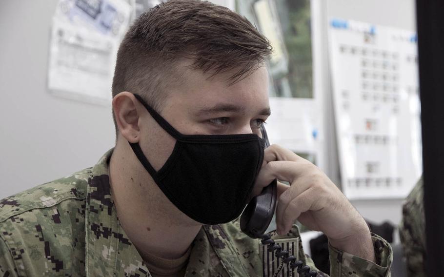 Seaman Justin Funder, 25, a hospitalman from St. Cloud, Minn., takes a call inside the COVID Cell at U.S. Naval Hospital Okinawa, Sept. 4, 2020.