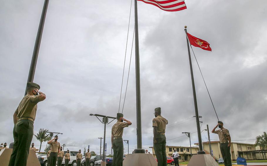 Marines salue after raising flags for the first time at the new Camp Blaz on Guam, Thursday, Oct. 1, 2020.