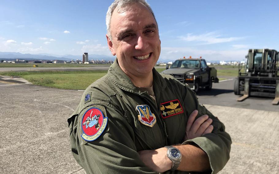 Lt. Col. Ben Craycraft, commander of the 4th Reconnaissance Squadron, shows off a new patch depicting a crow at Yokota Air Base, Japan, Sept. 30, 2020.