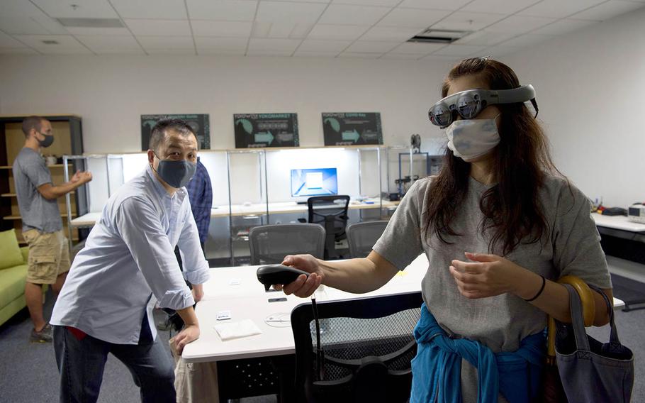 Kayoko Seta, 374th Contracting Squadron contracting specialist, experiences augmented reality for the first time in the newly-opened YokoWerx innovation lab at Yokota Air Base, Japan, Sept. 25, 2020.