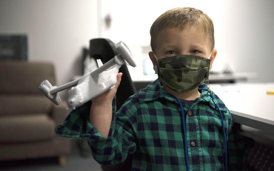 Finley Wilson, son of Master Sgt. Daniel Wilson, 5th Air Force intelligence, surveillance, reconnaissance and cyber effects operations superintendent, plays with a 3D printed CV-22 Osprey in the newly-opened YokoWerx innovation lab at Yokota Air Base, Japan, Sept. 25, 2020.