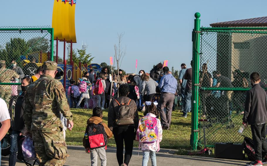 Parents and children arrive at a designated hug-n-drop area as students return to physical classrooms at Osan Elementary School on Osan Air Base, South Korea, Monday, Oct. 5, 2020.
