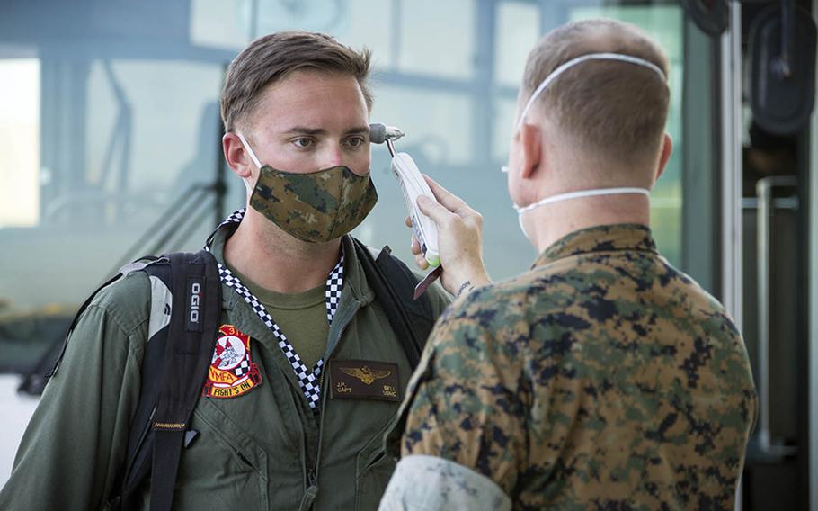 Capt. John Bell, a pilot with Marine Fighter Attack Squadron 312, is screened for coronavirus symptoms after arriving at Marine Corps Air Station Iwakuni, Japan, Oct. 2, 2020.