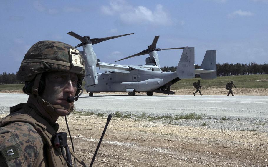 Forward air-controller Capt. David Kee stands by as Marines pour out of an MV-22 Osprey to seize the airfield at Ie Shima, Okinawa, Wednesday, Oct. 7, 2020, during the Noble Fury exercise.