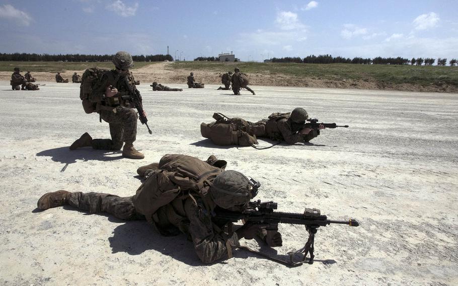 Marines take a defensive posture after exiting an MV-22 Osprey to seize the airfield at Ie Shima, Okinawa on Wednesday, Oct. 7, 2020, as part of Noble Fury drills.