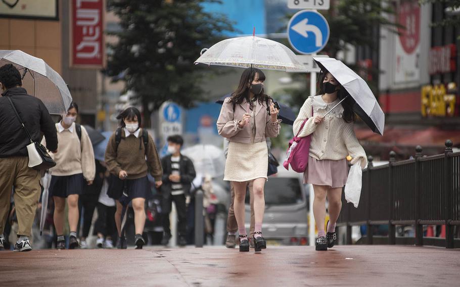 People wear face masks to guard against the coronavirus near Yokohama Station in Yokohama, Japan, Oct. 8, 2020.