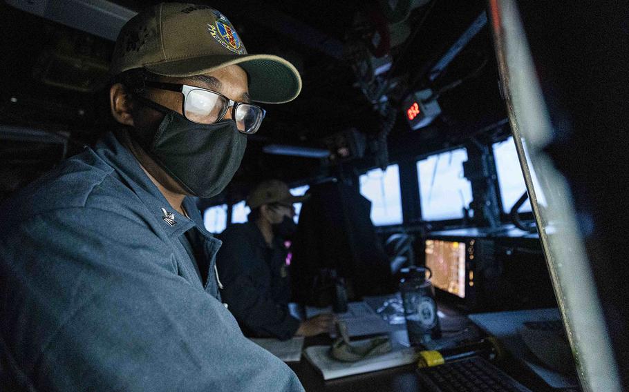 Petty Officer 2nd Class Noble Myrick, of Butler, Pa., stands watch in the pilot house of the guided-missile destroyer USS John S. McCain in the South China Sea, Oct. 12, 2020.