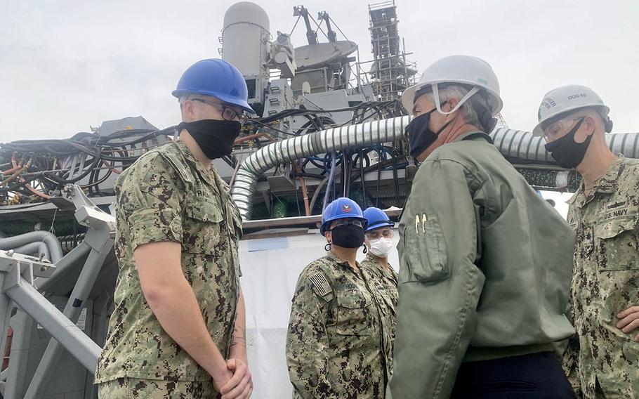 Navy Secretary Kenneth Braithwaite speaks with Petty Officer 3rd Class Justin Radai, a fire controlman, aboard the guided-missile destroyer USS Milius at Yokosuka Naval Base, Japan, Thursday, Oct. 15, 2020.