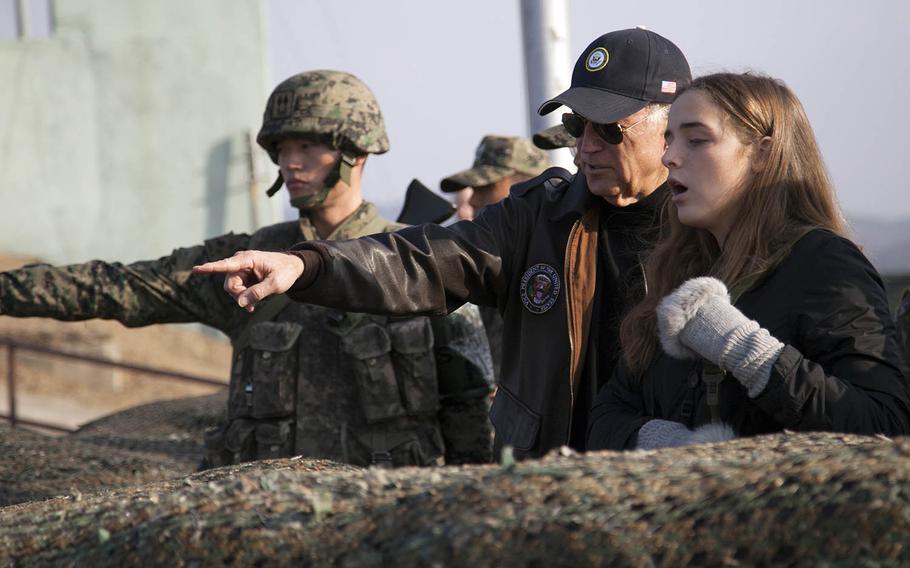 Then-Vice President Joe Biden points out an area of North Korea to his granddaughter, Finnegan Biden, during a visit to the Demilitarized Zone on Dec.7, 2013.