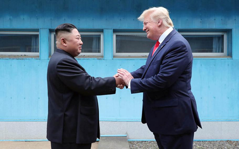 North Korean leader Kim Jong Un and President Donald Trump shake hands across the line separating North and South Korea on June 30, 2019.