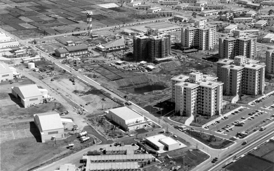 This aerial view of Yokota Air Base, Japan, shows housing towers and other buildings under construction on the east side in the mid-1970s.