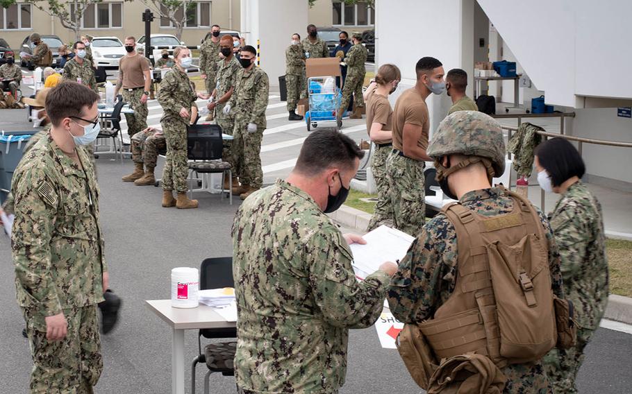 Sailors from the Branch Health Clinic at Marine Corps Air Station Iwakuni, Japan, innoculate active-duty troops with the flu vaccine to simulate a pandemic response during exercise Active Shield, Oct. 28, 2020.