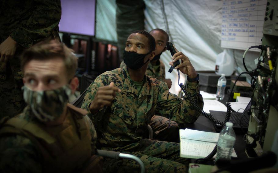 Cpl. William Teel, a radio operator with Marine Wing Support Squadron 171, passes information to his staff sergeant during the Active Shield exercise at Marine Corps Air Station Iwakuni, Japan, Oct. 28, 2020.