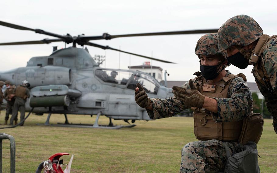 Sgt. Isiah Jakes of Marine Wing Support Squadron 171 takes part in a refueling operation for an AH-1 Cobra during an Active Shield drill at Marine Corps Air Station Iwakuni, Japan, Oct. 28, 2020.