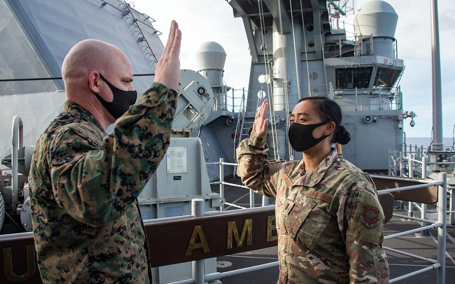 First Lt. Rio Sarmiento, right, is sworn into the Space Force during a two-month patrol aboard the USS America, Sept. 17, 2020.