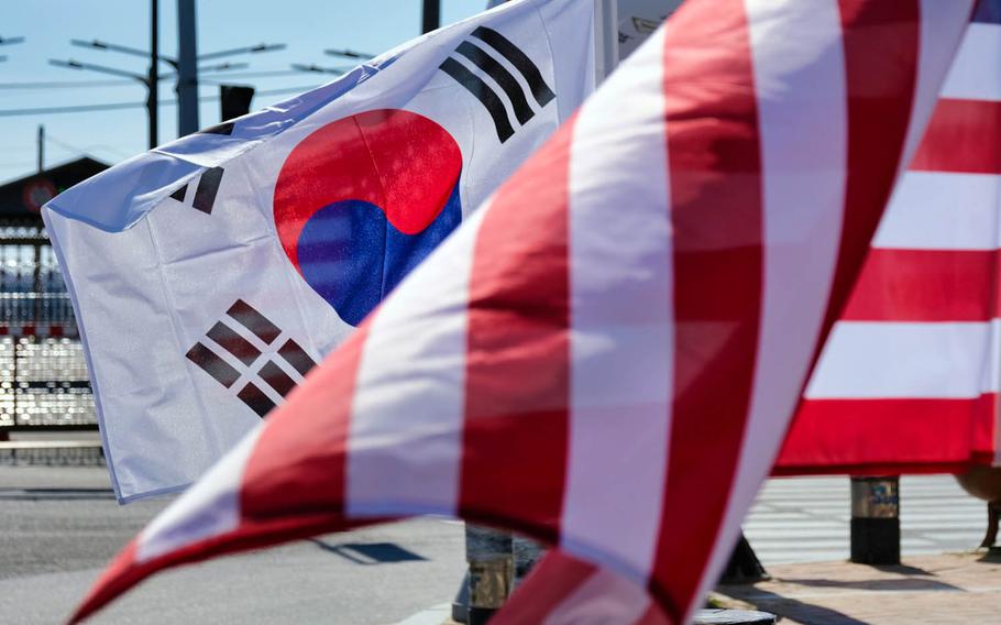 U.S. and South Korean flags flap in the wind outside Camp Humphreys, South Korea, March 16, 2020.