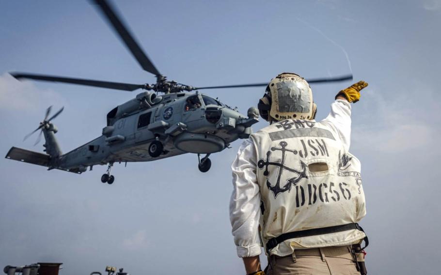 A Royal Australian Navy MH-60R Seahawk helicopter takes off from the guided-missile destroyer USS John S. McCain during Malabar drills in the Bay of Bengal, Tuesday, Nov. 3, 2020.