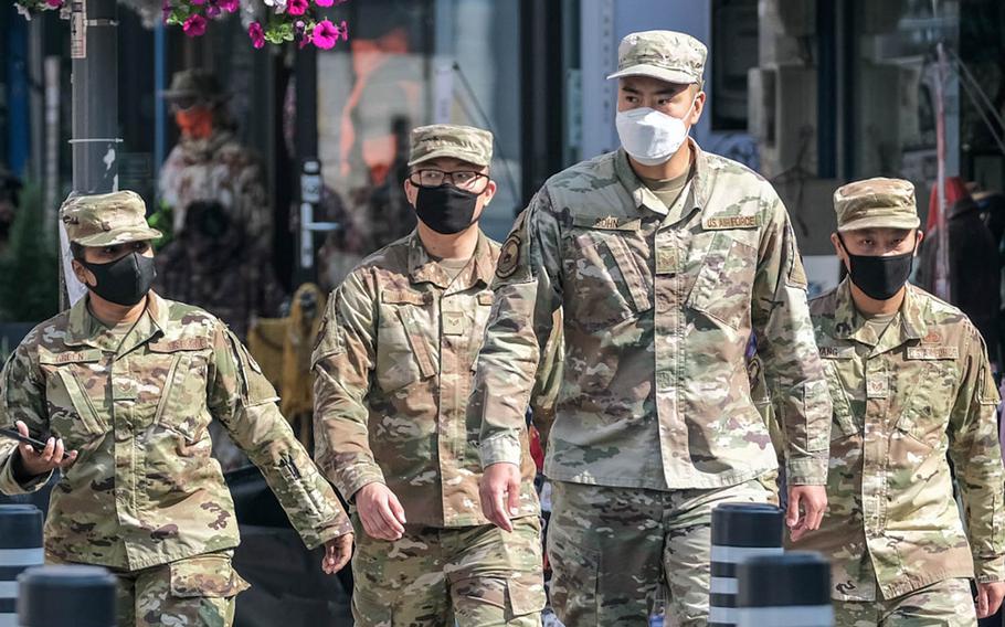Airmen from the 51st Fighter Wing wear masks as they stroll outside Osan Air Base, South Korea, Oct. 21, 2020.