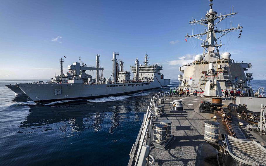 The guided-missile destroyer USS John S. McCain conducts a replenishment-at-sea with the Indian navy fleet tanker INS Shakti and the Royal Australian Navy frigate HMAS Ballarat during Malabar drills in the Indian Ocean, Nov. 4, 2020.