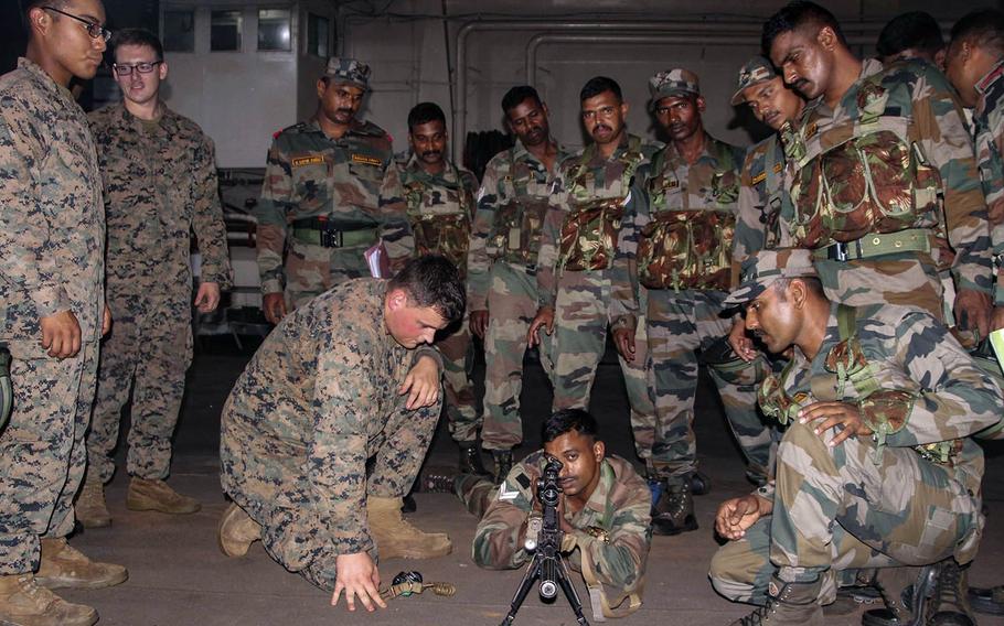 U.S. Marines and Indian soldiers educate one another about their respective weapon systems during exercise Tiger Triumph aboard the INS Jalashwa in India, Nov. 17, 2019.