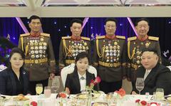 In this photo provided by the North Korean government, North Korean leader Kim Jong Un, right, with his wife Ri Sol Ju, left, and his daughter poses with military top officials for a photo at a feast to mark the 75th founding anniversary of the Korean People’s Army at an unspecified place in North Korea Tuesday, Feb. 7, 2023. Independent journalists were not given access to cover the event depicted in this image distributed by the North Korean government. The content of this image is as provided and cannot be independently verified. Korean language watermark on image as provided by source reads: "KCNA" which is the abbreviation for Korean Central News Agency. 