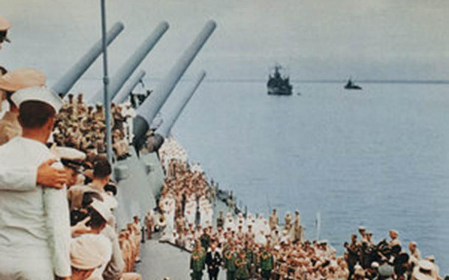 Spectators crowd the decks of the USS Missouri in Tokyo Bay on Sept. 2, 1945, as officials of Imperial Japan sign the formal surrender document that ended World War II. 