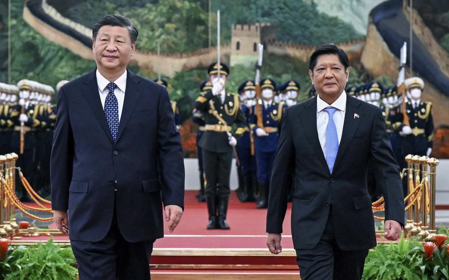 In this photo released by Xinhua News Agency, Visiting Philippine President Ferdinand Marcos Jr., right, walks with Chinese President Xi Jinping after reviewing an honor guard during a welcome ceremony at the Great Hall of the People in Beijing on Jan. 4, 2023.  Marcos said Monday, Jan. 23, 2023 he has proposed to China that the two countries hold talks between their foreign ministers to quickly resolve any new conflicts in the disputed South China Sea, and blamed Chinese actions for the disagreements. 