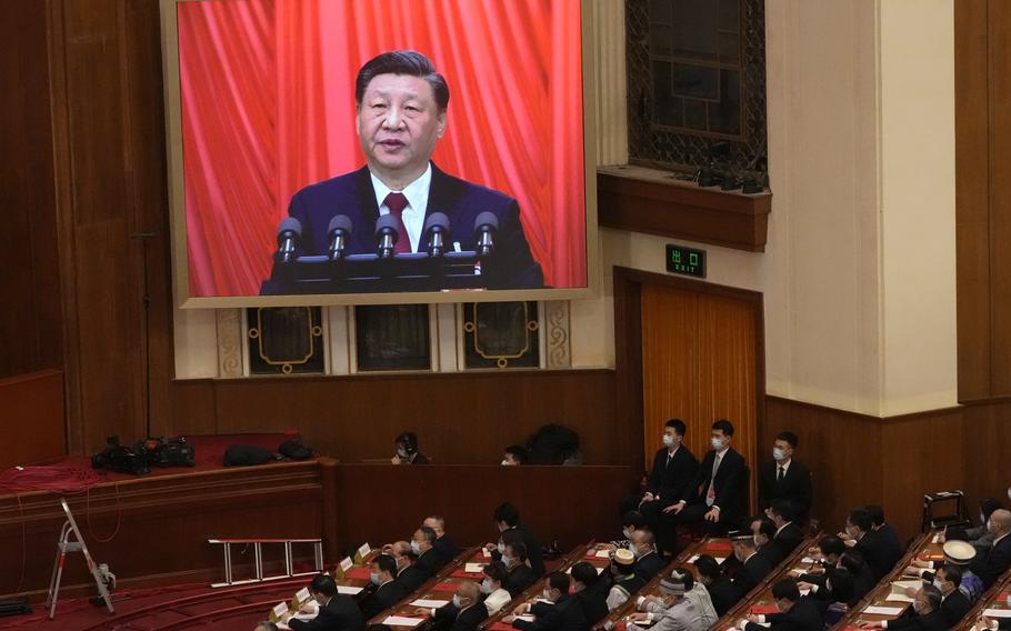 Chinese President Xi Jinping is displayed on a screen as he delivers a speech at the closing ceremony for China's National People's Congress (NPC) at the Great Hall of the People in Beijing, Monday, March 13, 2023. 