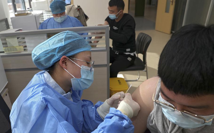 A nurse gives a shot of the Sinopharm COVID-19 vaccine developed by Beijing Institute of Biological Products Co. Ltd. to an airport worker at a health station in Nantong in east China’s Jiangsu province on Jan. 29, 2021.