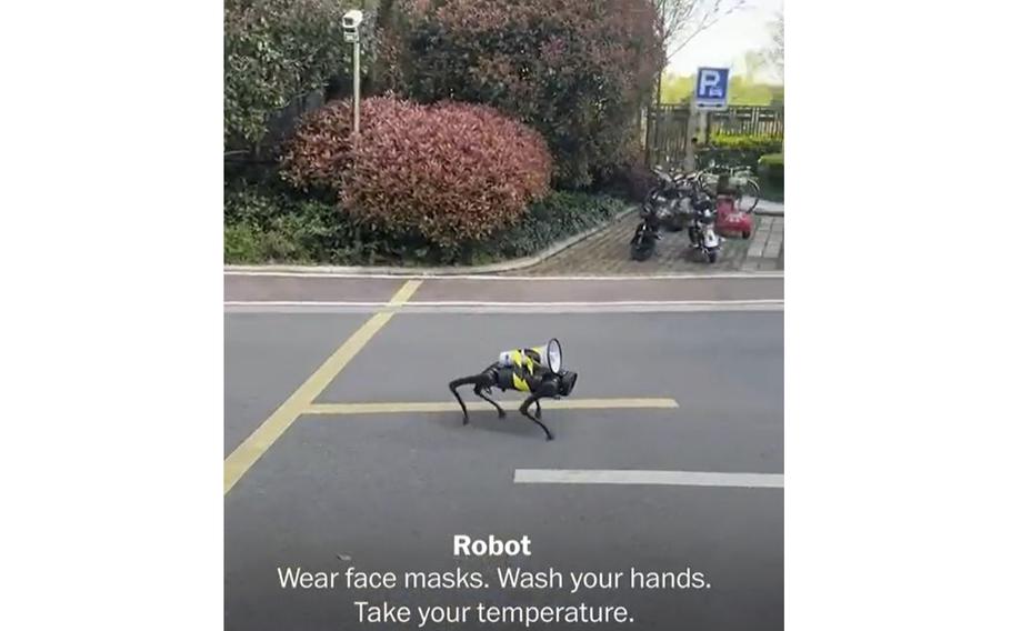 A video screen grab shows a robotic four-legged creature with a megaphone on top of its back playing recorded coronavirus pandemic instructions as it walks down a deserted street in Shanghai, China