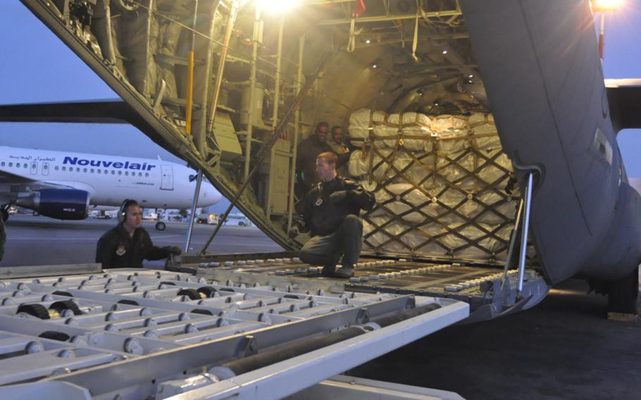 Airmen from the 37th Airlift Squadron and the 435th Airlift Mobility Squadron unload cargo from the U.S. Agency for International Development at Tunisia’s Djerba Zarzis airport. The supplies will be distributed to refugees who have fled the escalating violence in Libya. 
