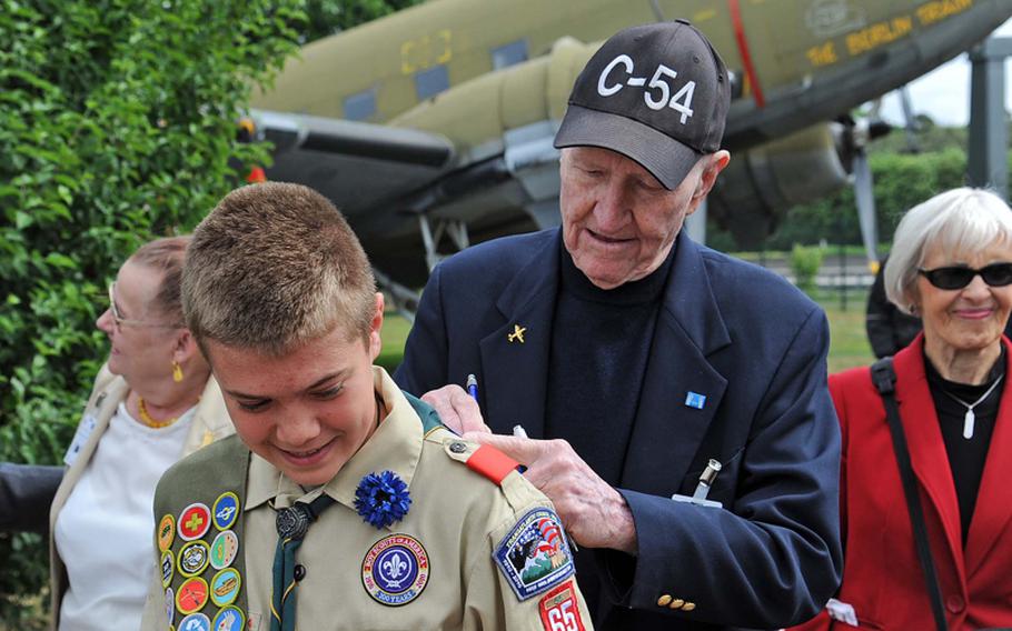 "Candy Bomber" Gail Halvorsen signs an autograph for Caleb Magowan of Wiesbaden Boy Scout Troop 65 at a ceremony Monday in Frankfurt, Germany, commemorating the 62nd anniversary of the end of the Berlin Airlift. The Scouts, along with soldiers and members of the Junior ROTC from Wiesbaden, participated in the ceremony. 
