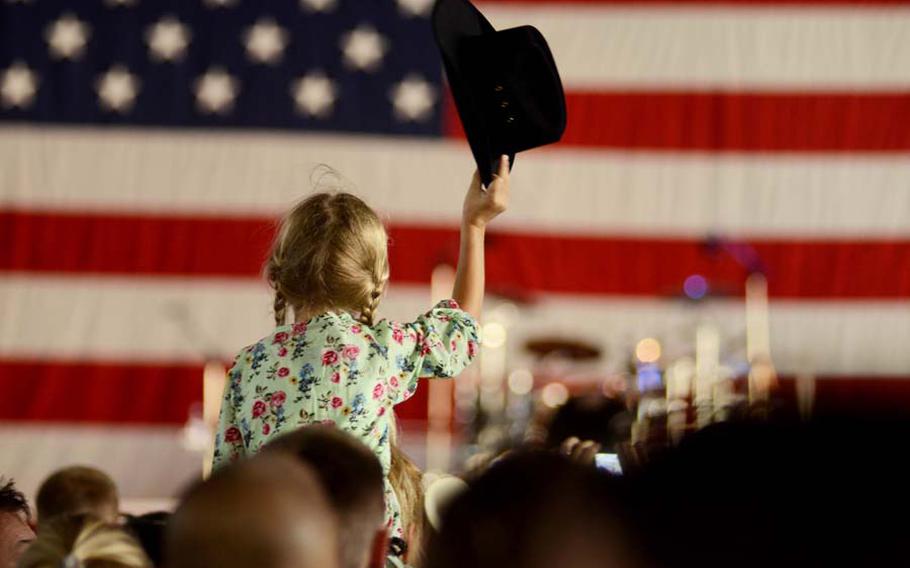 Annabella Seidl, 6, waves her cowgirl hat before country music star Trace Adkins came on stage. Adkins performed on Ramstein Air Base Sunday to commemorate the 10th anniversary of 9/11. The free concert, sponsored by the United Services Organization, was held in a hangar on base.