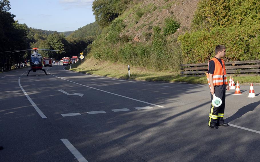 Pascal Zirkel, a German firefighter with the village of Krickenbach, helps block traffic on highway B-270 outside the entrance to the village of Schopp on Wednesday, after what's believed to be a World War II-era phosphorous bomb was discovered behind the Schopp train station, according to local firefighters at the scene.