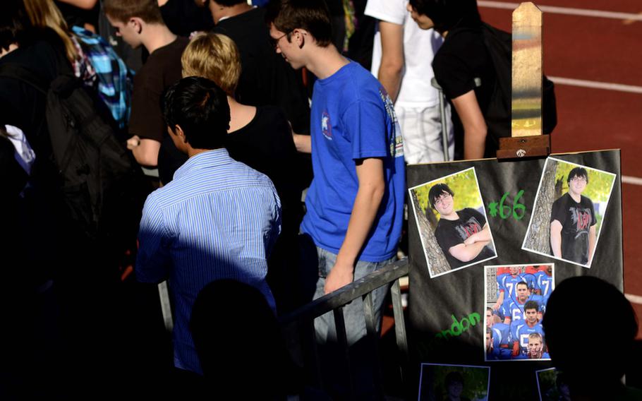 Ramstein High School students gather at the school's football field to remember Brendon Holtzen, the 17-year-old stepson of an American servicemember, who was killed Wednesday evening in a car crash near Ramstein.