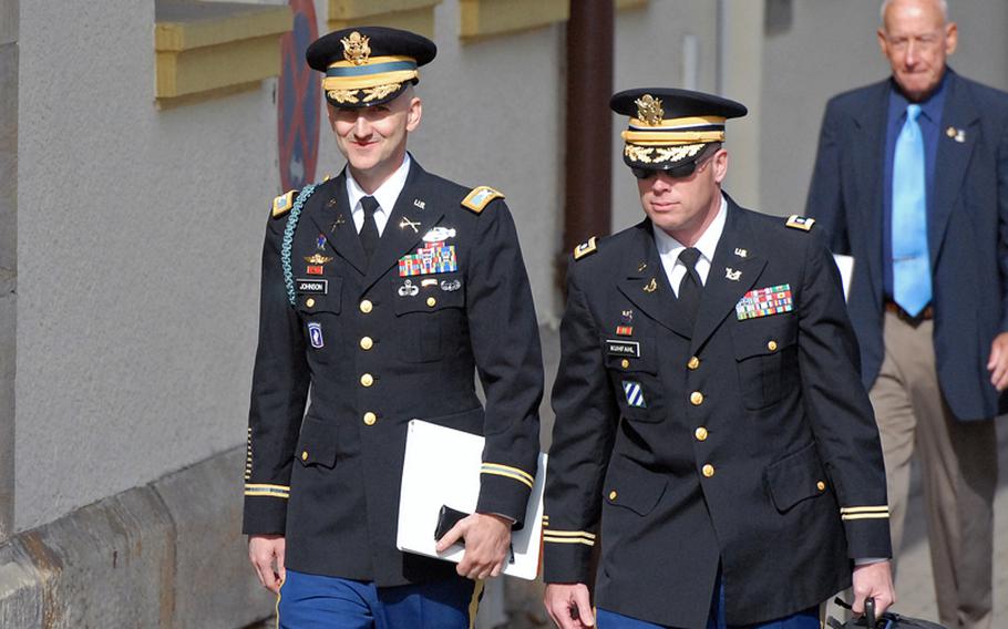 Col. James H. Johnson III, left, walks with his defense counsel Lt. Col. Charles Kuhfahl, to the courtroom at Kleber Kaserne in Kaiserslautern, Germany, for the opening day of his court-martial.  Johnson pleaded guilty to 15 of 27 specifications, including bigamy, adultery and fraud.  Behind them is Johnson's father, retired Lt. Gen. James H. Johnson Jr.